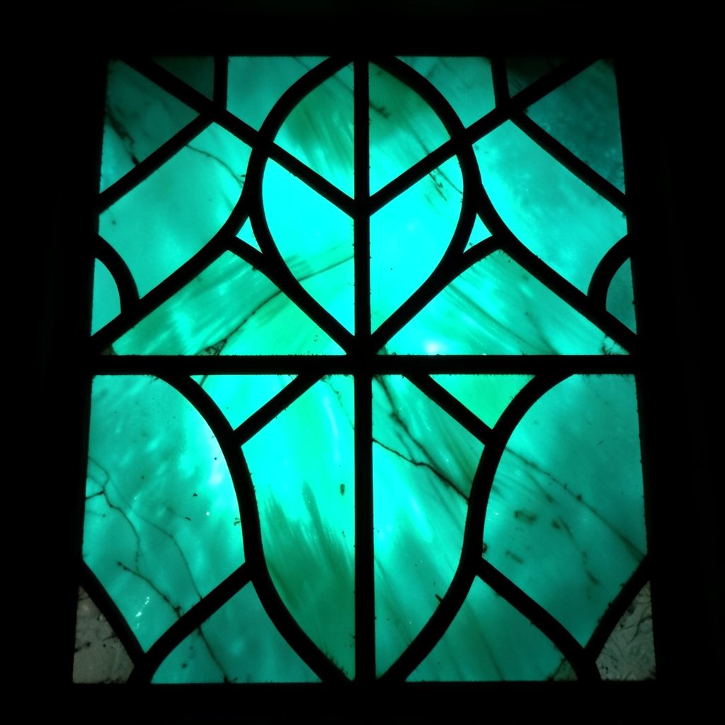 A warm abstract composition in soft gold and cream tones with a single peacock-blue accent, evoking a sunlit garden viewed through translucent paper.